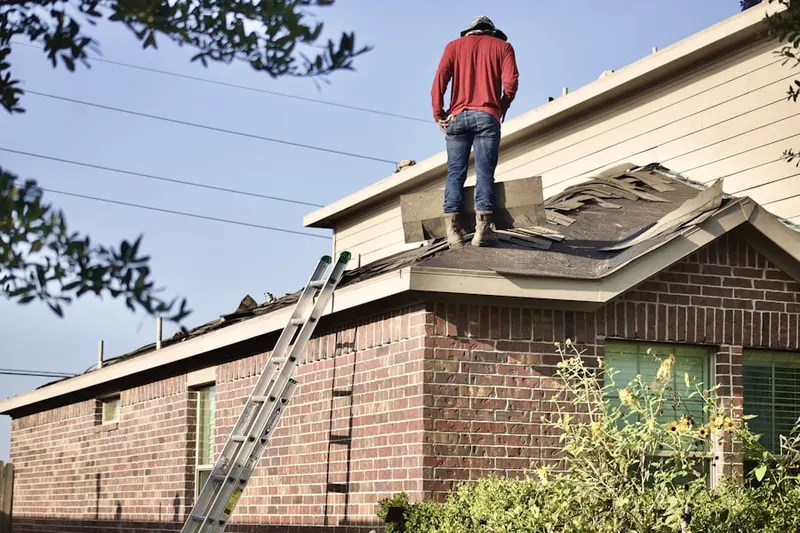 Professional roofer working on a residential roof in Easley